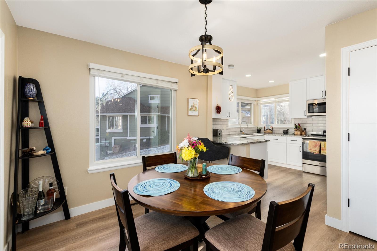 4010 South Rifle Way Aurora, CO 80013 - Photo 10 of 45 a view of a dining room with furniture and a chandelier