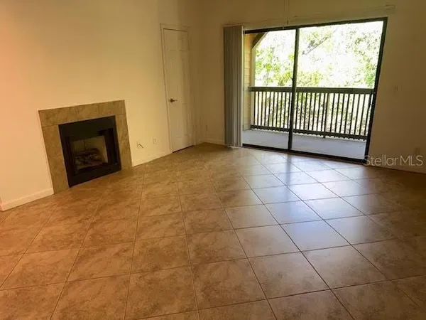 a view of a livingroom with a fireplace and large window