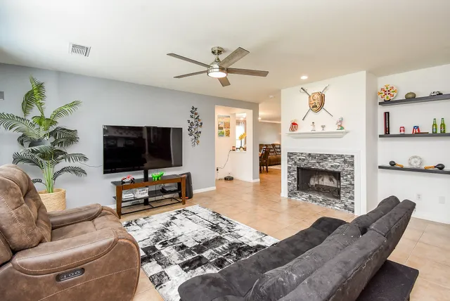 a living room with furniture and a fireplace