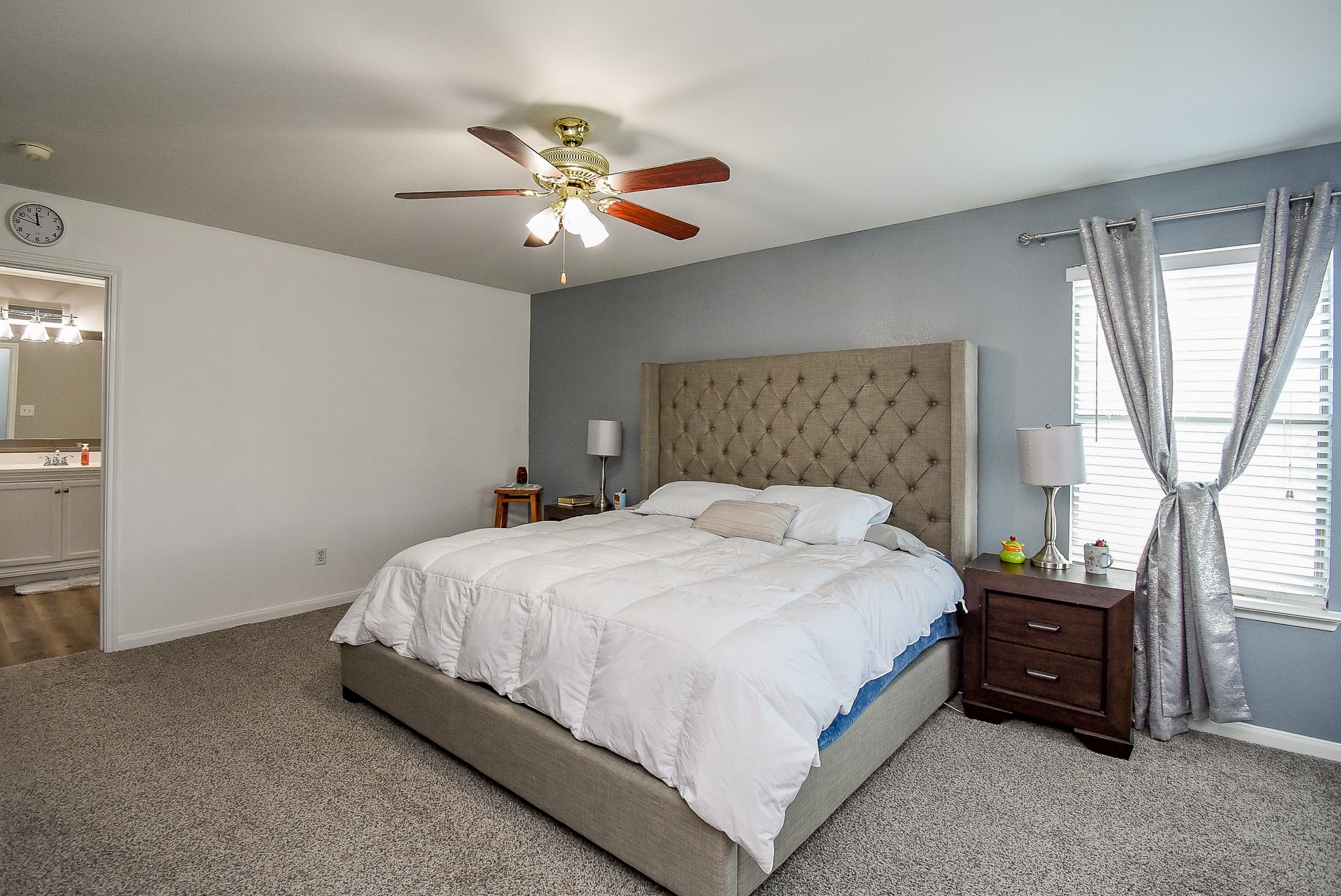 6111 Harvest Terrace Court Spring, TX 77379 - Photo 15 of 32 a bedroom with a bed and a chandelier