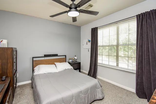 a bedroom with a bed and a chandelier