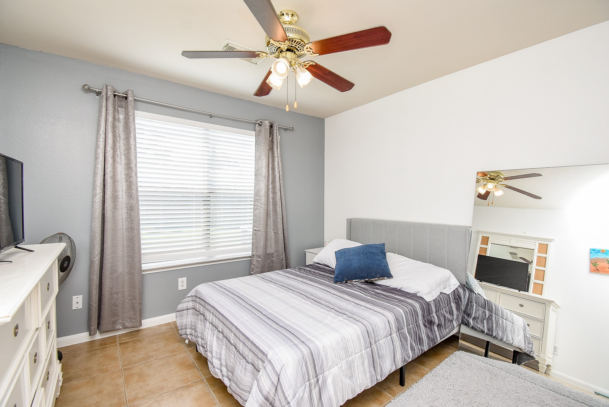 6111 Harvest Terrace Court Spring, TX 77379 - Photo 24 of 32 a bedroom with a bed and a ceiling fan