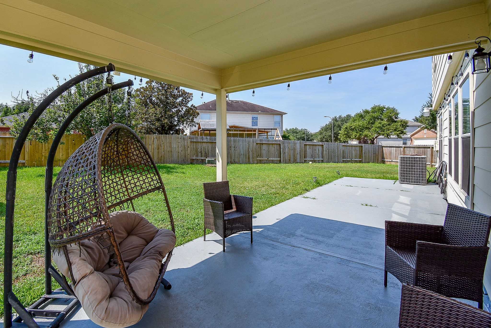 6111 Harvest Terrace Court Spring, TX 77379 - Photo 29 of 32 a view of patio with table and chairs under an umbrella