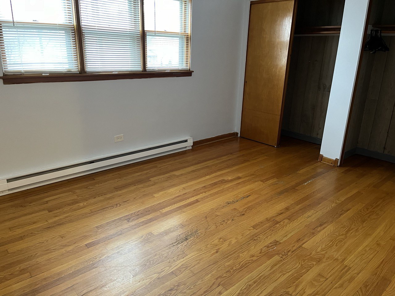 2415 Thornton Lansing Road, Unit 1 Lansing, IL 60438 - Photo 4 of 7 an empty room with wooden floor and windows