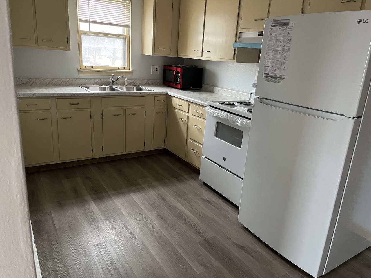 2415 Thornton Lansing Road, Unit 1 Lansing, IL 60438 - Photo 6 of 7 a kitchen with stainless steel appliances granite countertop a stove a sink and a refrigerator