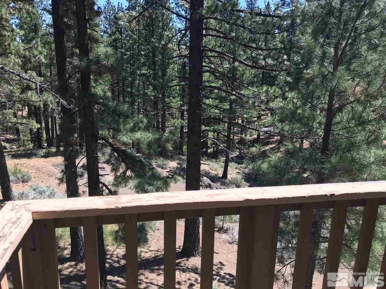 60 Lava Cap Markleeville, CA 96120 - Photo 19 of 20 a view of a wooden deck and trees in the background