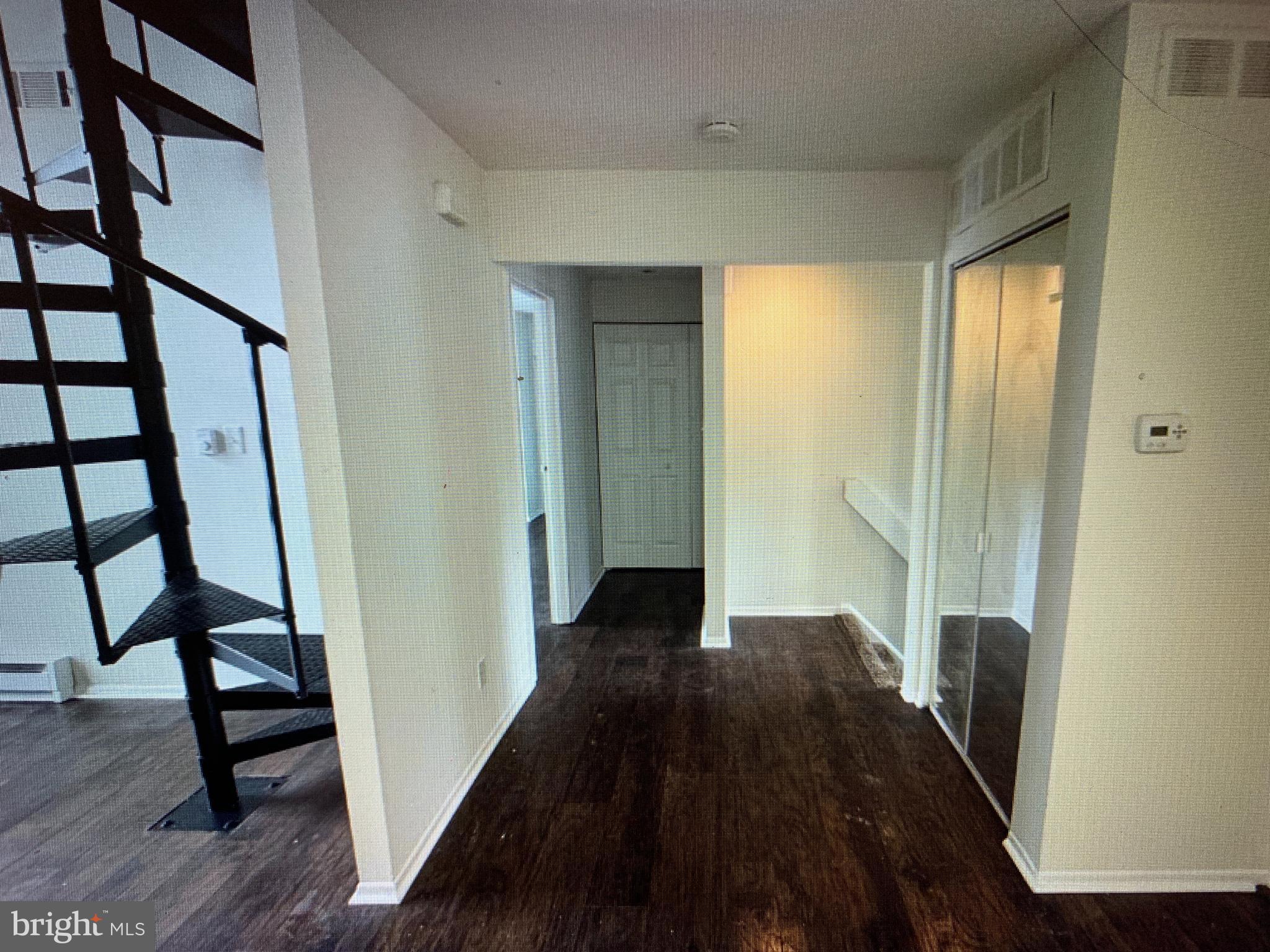 502 Bromley Clementon, NJ 08021 - Photo 3 of 10 a view of a hallway with wooden floor and staircase