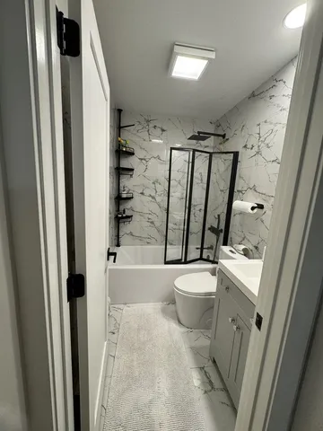 a bathroom with a toilet and a shower