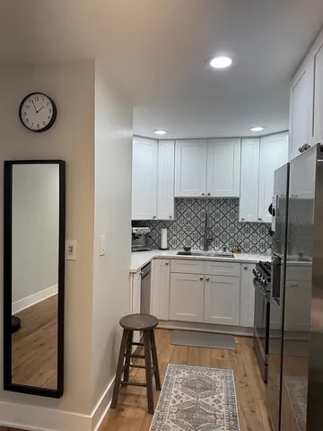 a kitchen with a refrigerator and a stove top oven