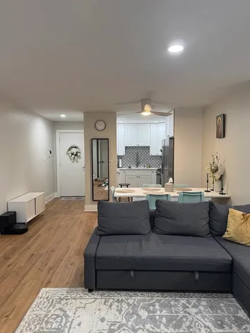 a view of kitchen with kitchen island microwave and cabinets