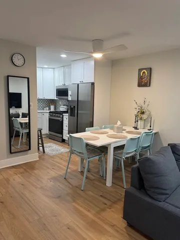 a view of a dining room with furniture and wooden floor