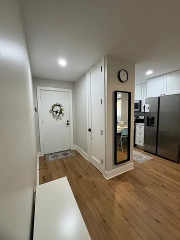 a view of a hallway with wooden floor