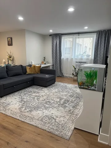 a living room with furniture window and wooden floor