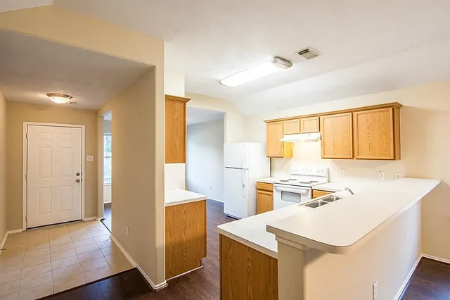 a kitchen with a sink a stove and refrigerator