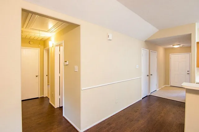a view of a hallway with a wooden floor