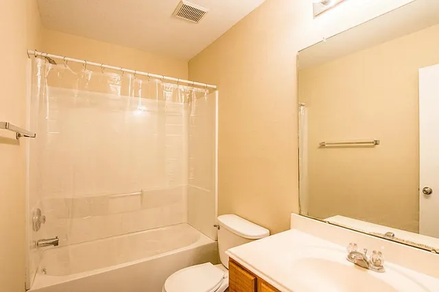 a bathroom with a shower curtain and a sink