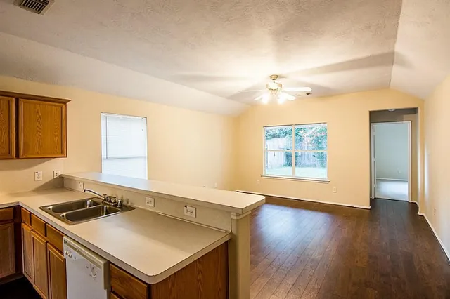a kitchen that has a sink and a stove in it