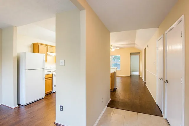 a view of a hallway with wooden floor
