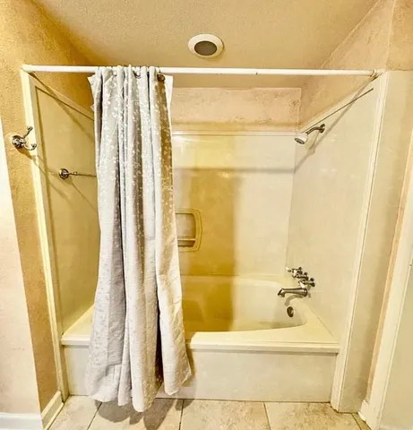 a bathroom with a shower and a tub