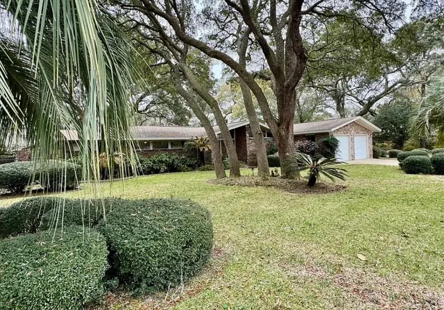 a view of a house with backyard and sitting area