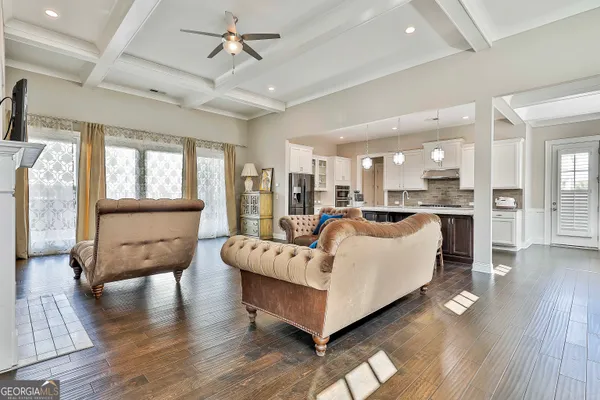 a living room with furniture and kitchen view