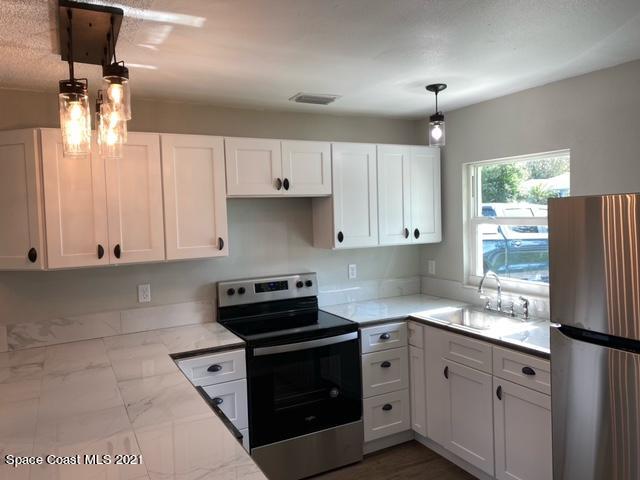 5401 Flint Road Cocoa, FL 32927 - Photo 2 of 13 a kitchen with cabinets appliances and a window