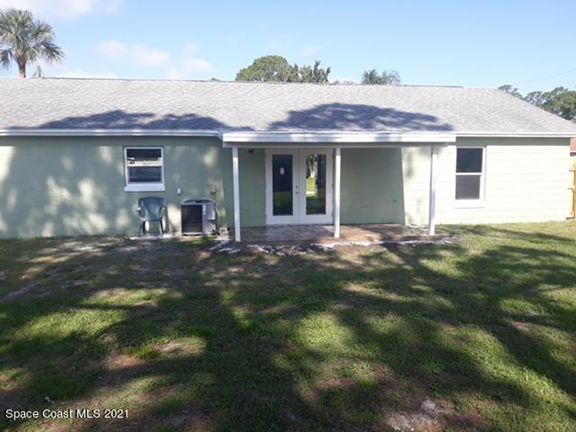 5401 Flint Road Cocoa, FL 32927 - Photo 11 of 13 a front view of a house with a yard