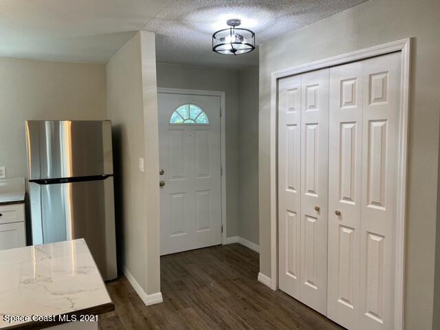 5401 Flint Road Cocoa, FL 32927 - Photo 4 of 13 a view of a hallway with wooden floor and staircase