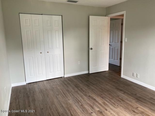 5401 Flint Road Cocoa, FL 32927 - Photo 9 of 13 a view of an empty room with wooden floor and closet