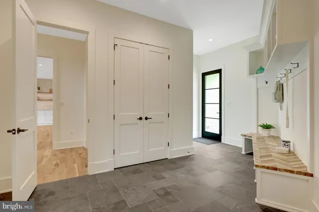 a view of a hallway with wooden floor and entryway