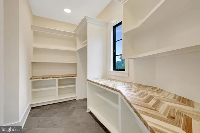a view of a hallway with wooden floor and windows