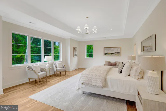 a spacious bathroom with double vanity a mirror a vanity and a bathtub
