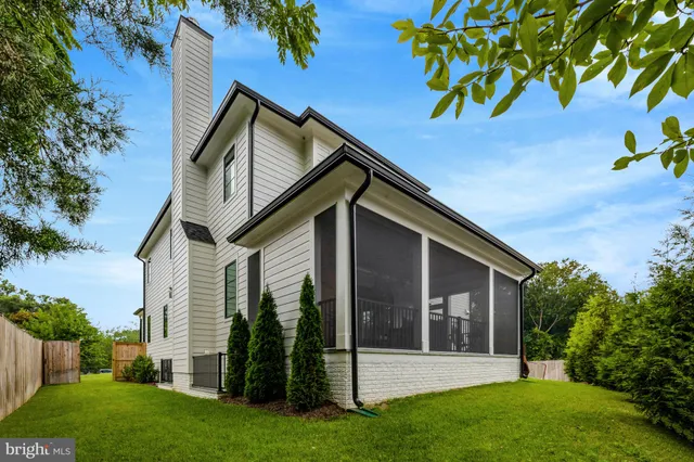a view of a house with backyard sitting area and garden