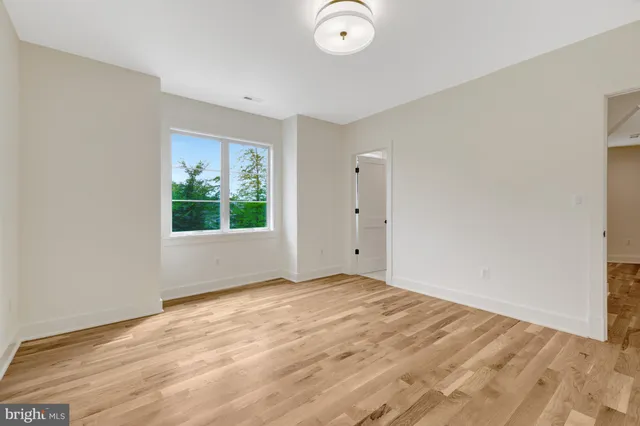 a bathroom with a toilet a sink a tub and mirror