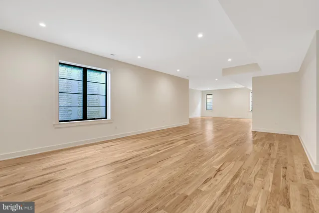 a bathroom with a granite countertop toilet a sink and a mirror