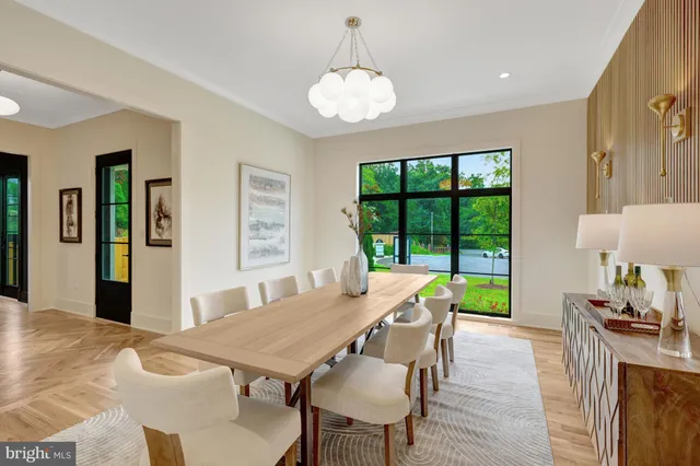 a living room with furniture a flat screen tv and a floor to ceiling window