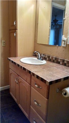 1120 Blake Road Lyles, TN 37098 - Photo 9 of 20 Updated Master bath vanity with ceramic tile floor & counter tops ~ Linen closet