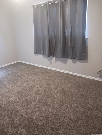 a view of room that has wooden floor