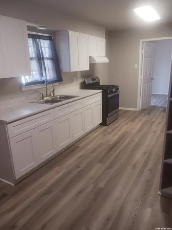 a kitchen with a sink cabinets and window