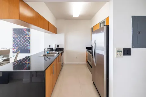 a kitchen with a refrigerator and a sink