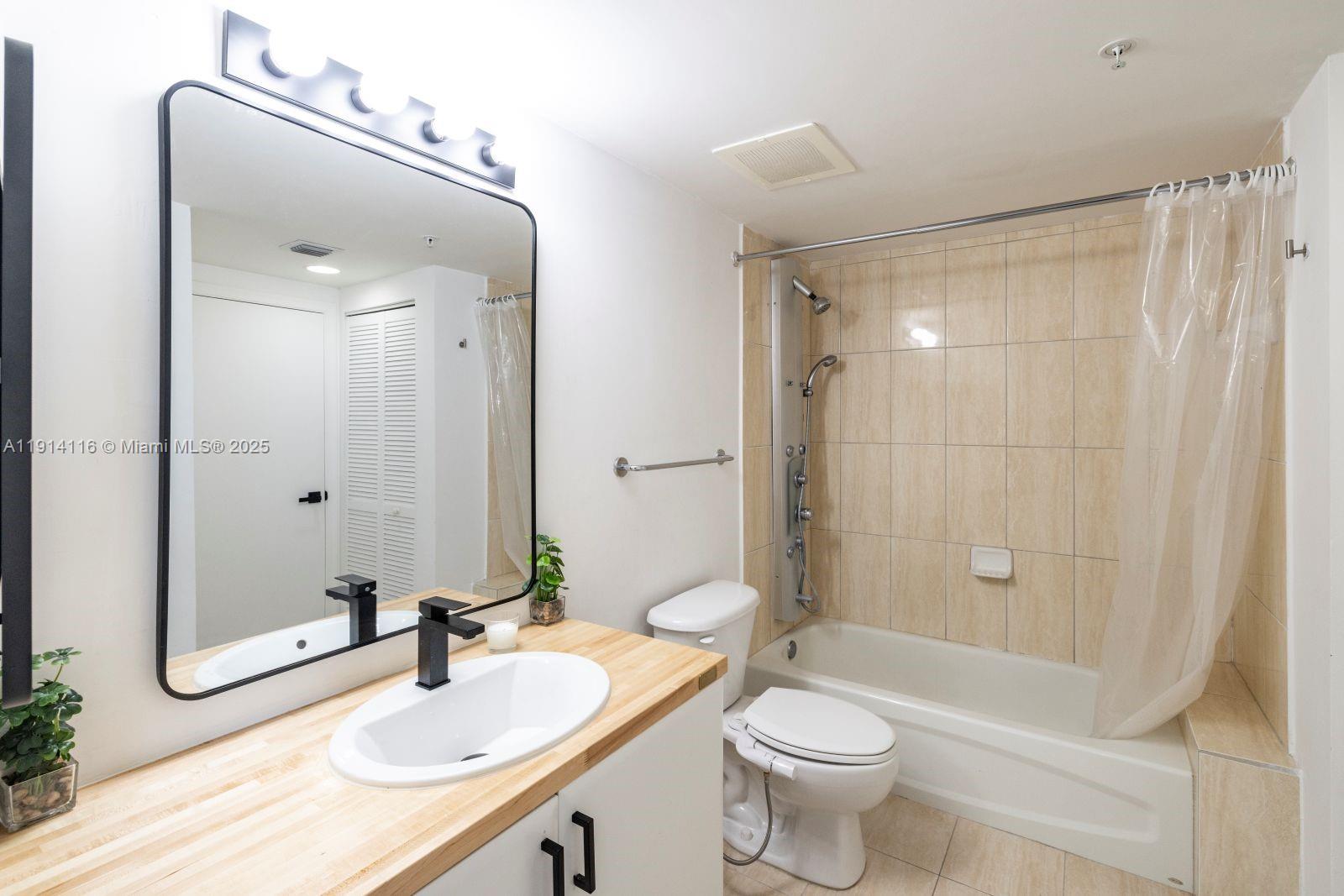 1750 North Bayshore Drive, Unit 4312 Miami, FL 33132 - Photo 7 of 10 a bathroom with a sink a toilet and shower