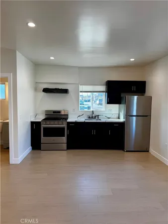 a kitchen with stainless steel appliances a refrigerator and a sink