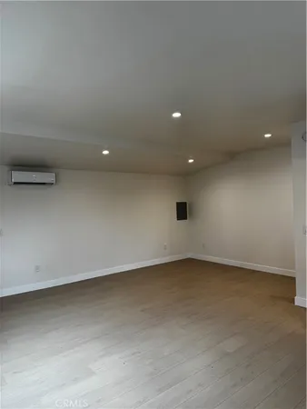 an empty room with a ceiling fan and window