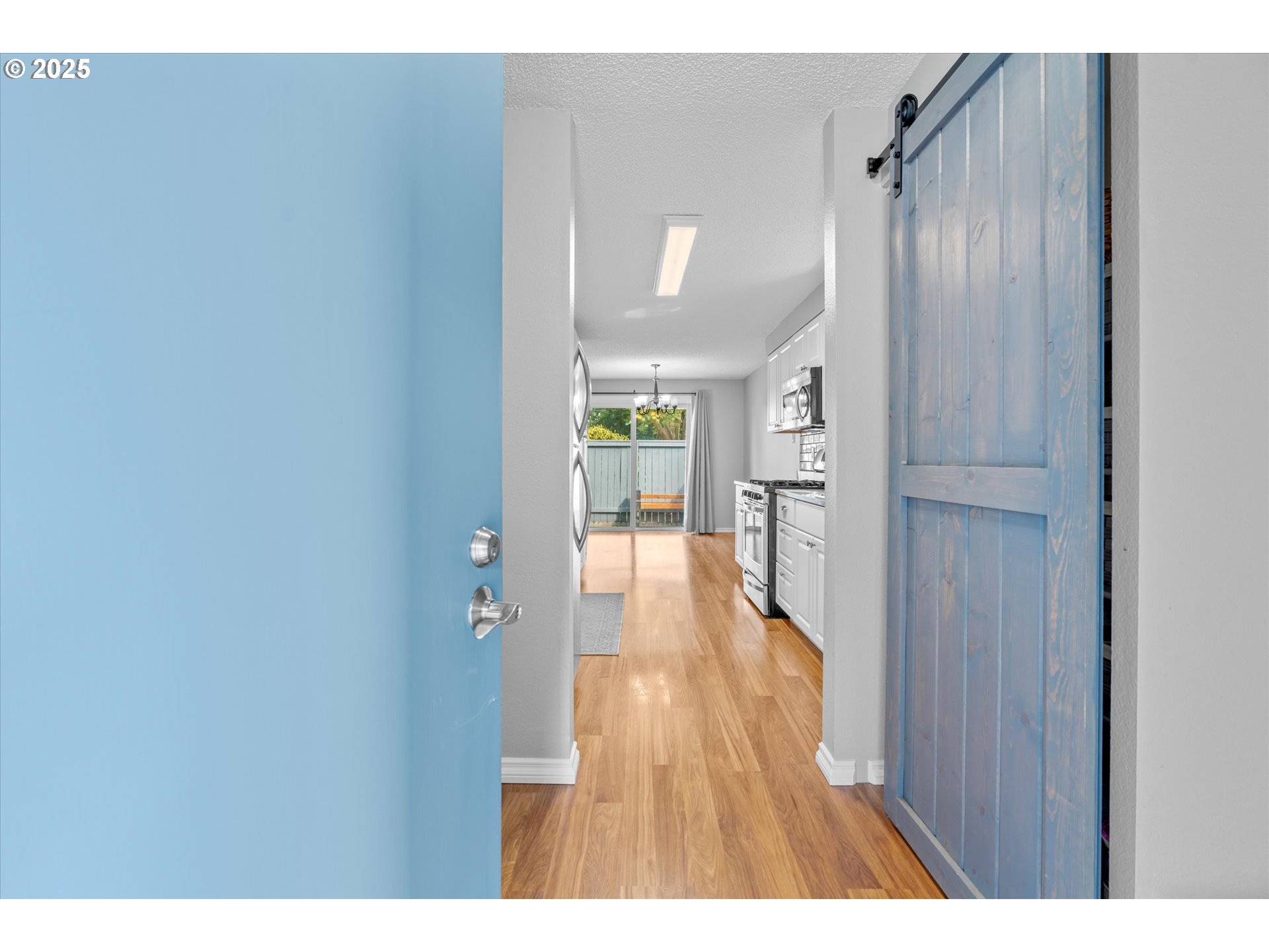 827 Northeast 90th Avenue Portland, OR 97220 - Photo 5 of 38 a open kitchen with white cabinets and wooden floor