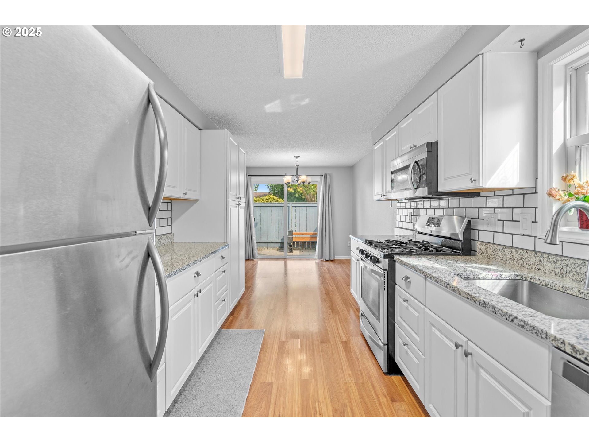 827 Northeast 90th Avenue Portland, OR 97220 - Photo 6 of 38 a open kitchen with stainless steel appliances granite countertop a sink stove and refrigerator