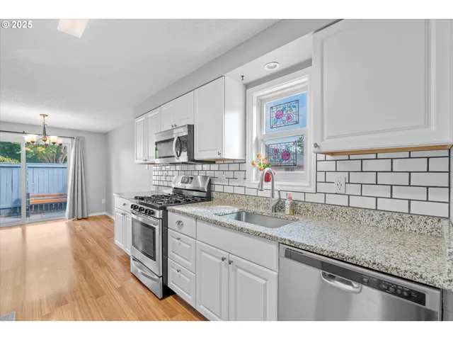a stove top oven sitting inside of a kitchen