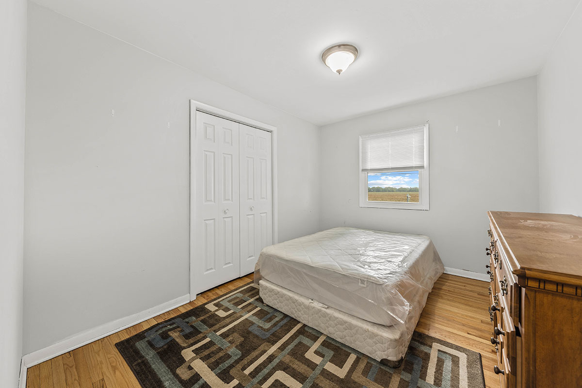 815 Bronk Road Joliet, IL 60404 - Photo 13 of 23 a bedroom with a bed and a window