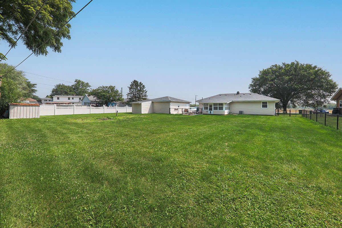 815 Bronk Road Joliet, IL 60404 - Photo 23 of 23 a view of a house with a big yard and palm trees