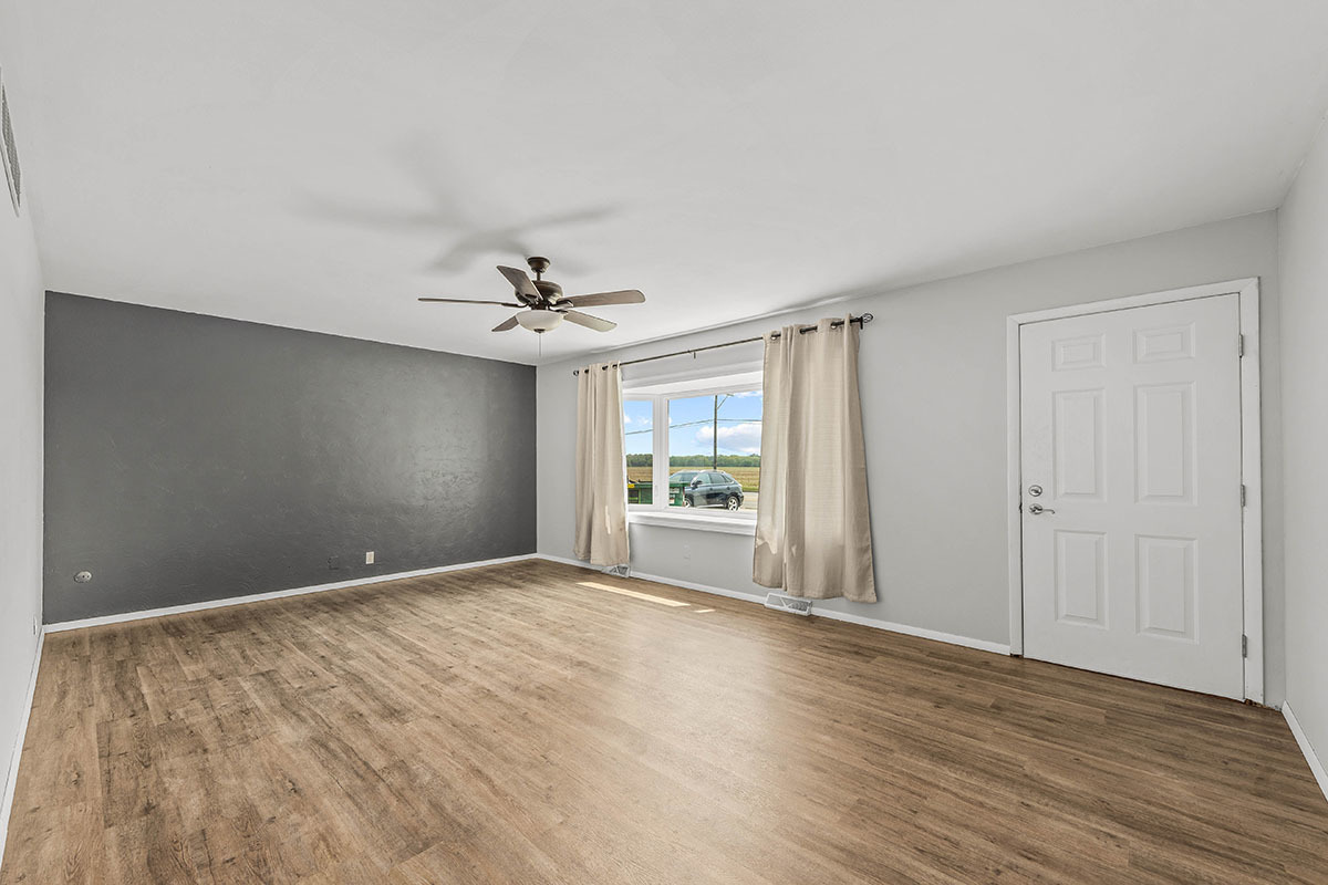 815 Bronk Road Joliet, IL 60404 - Photo 3 of 23 a view of an empty room with window and wooden floor