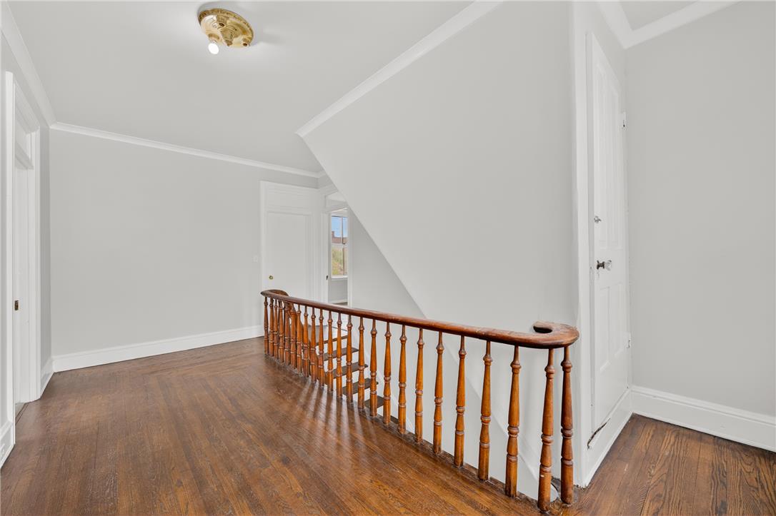 65 2nd Street Slatington, PA 18080 - Photo 27 of 46 This landing area features rich hardwood flooring and a classic wooden banister, leading to upper and lower levels.